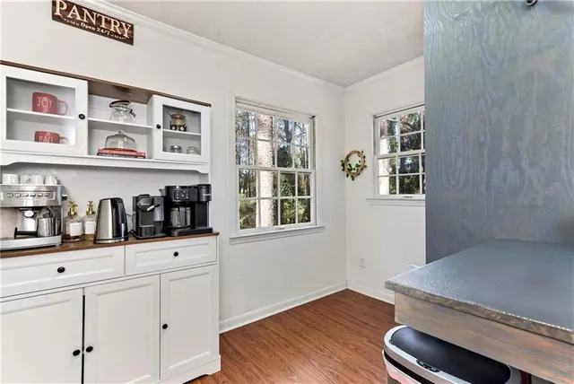a kitchen with granite countertop white cabinets white appliances and sink