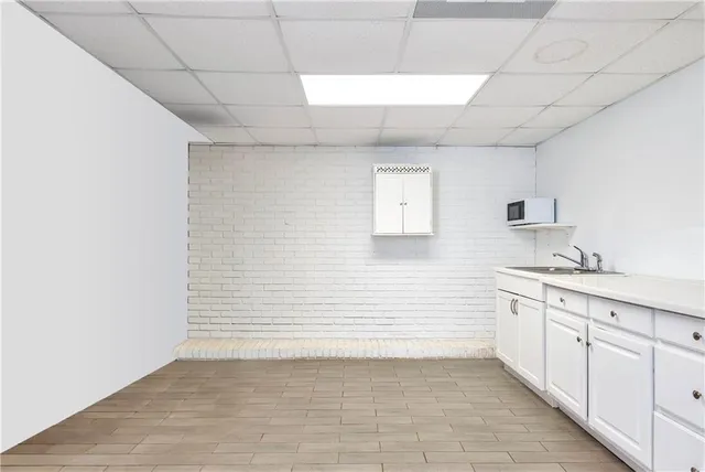 a bedroom with a bed and a lamp on dresser