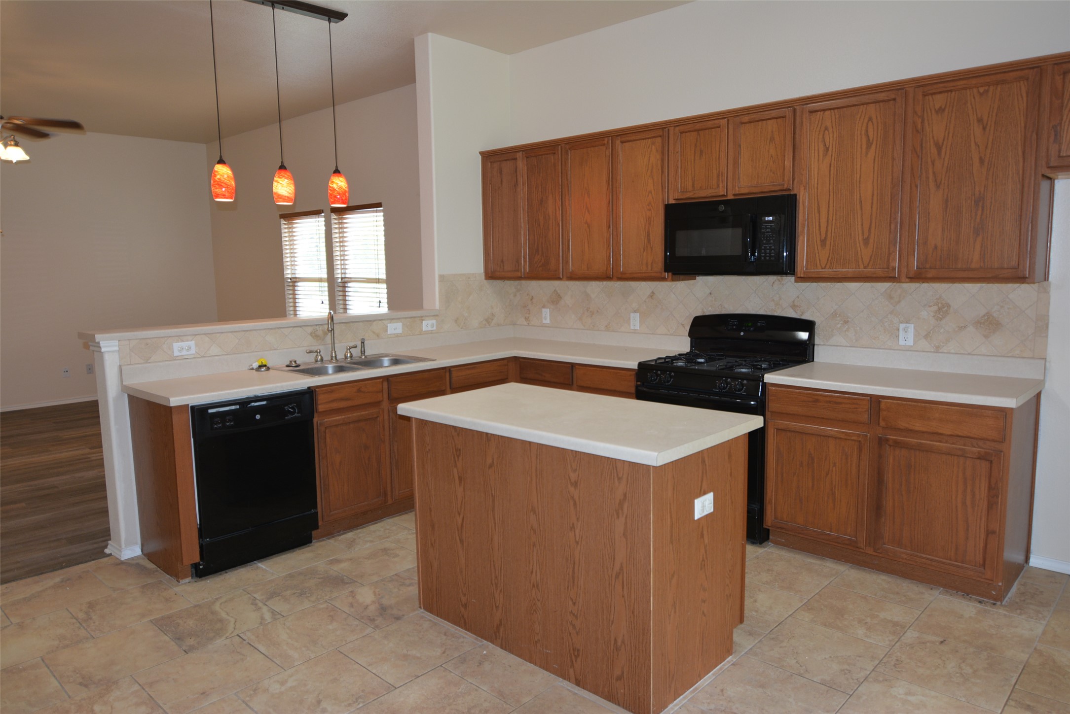 1303 Horseshoe Ranch Drive Leander, TX 78641 - Photo 8 of 26 A functional kitchen boasts ample counter space and a central island, perfect for culinary endeavors.