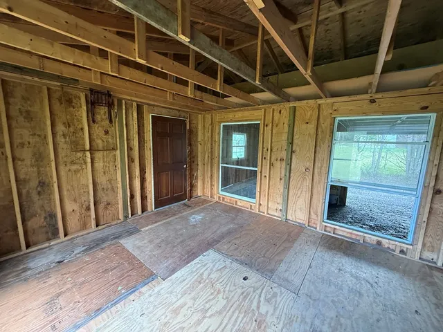 a view of a room with wooden floor and windows