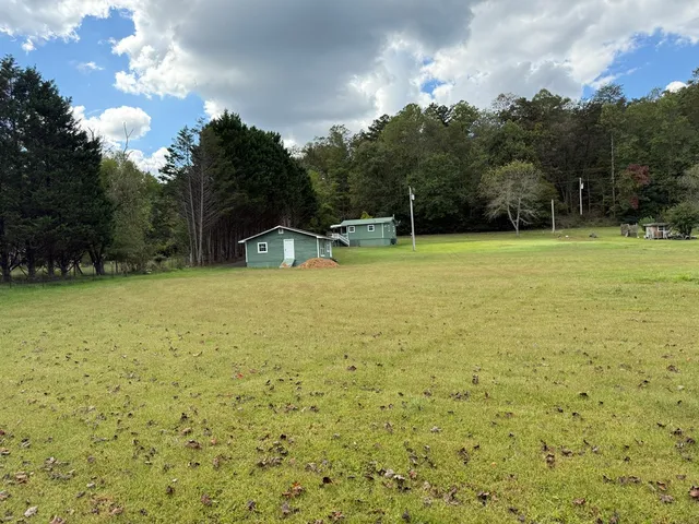 a view of a hallway with wooden floor and windows