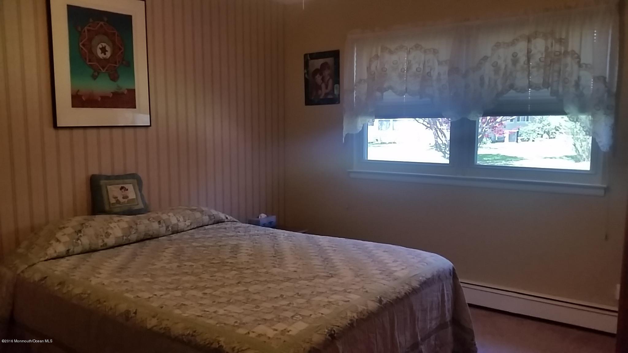 24 East Road, Unit A Jackson, NJ 08527 - Photo 16 of 24 a bed sitting in a bedroom next to a window