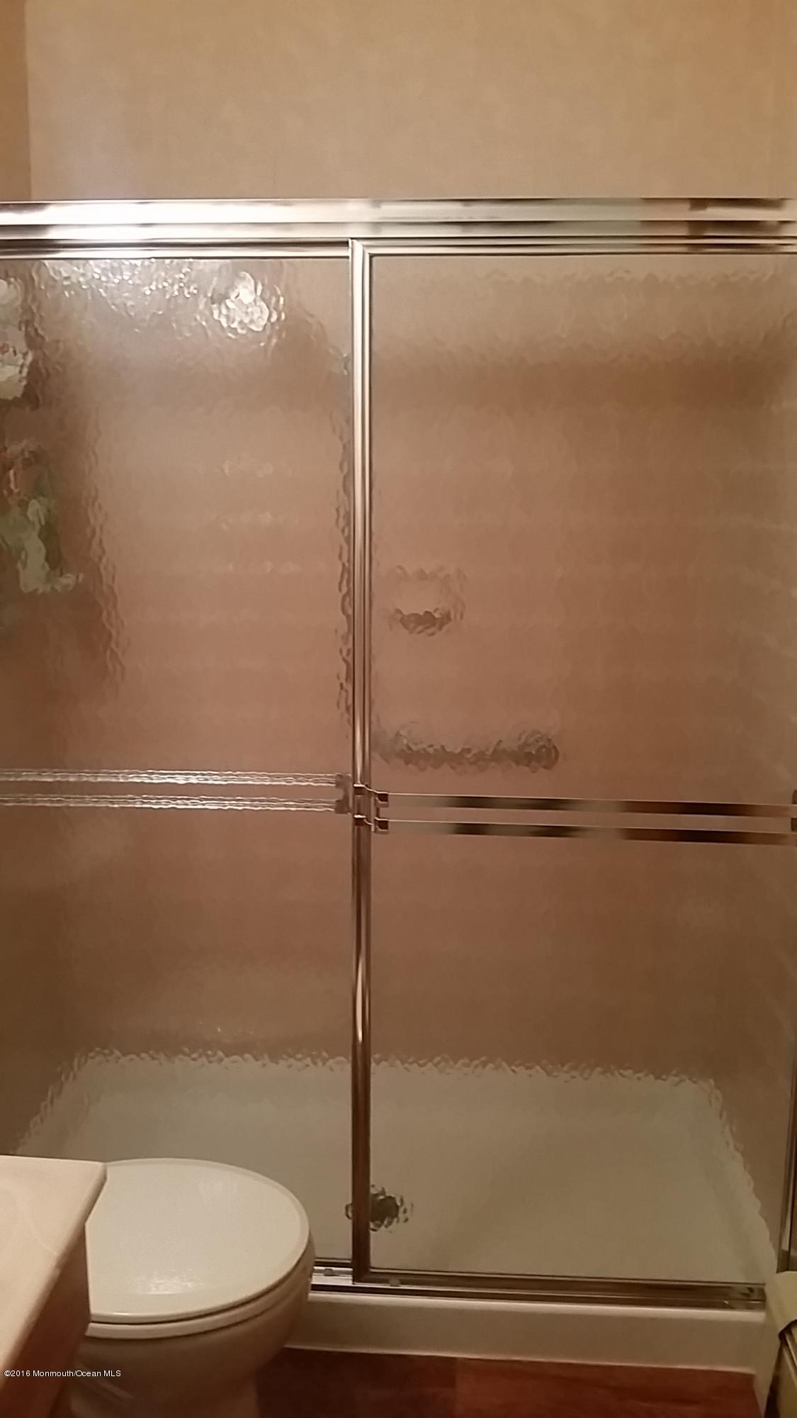 24 East Road, Unit A Jackson, NJ 08527 - Photo 20 of 24 a bathroom with a glass shower door