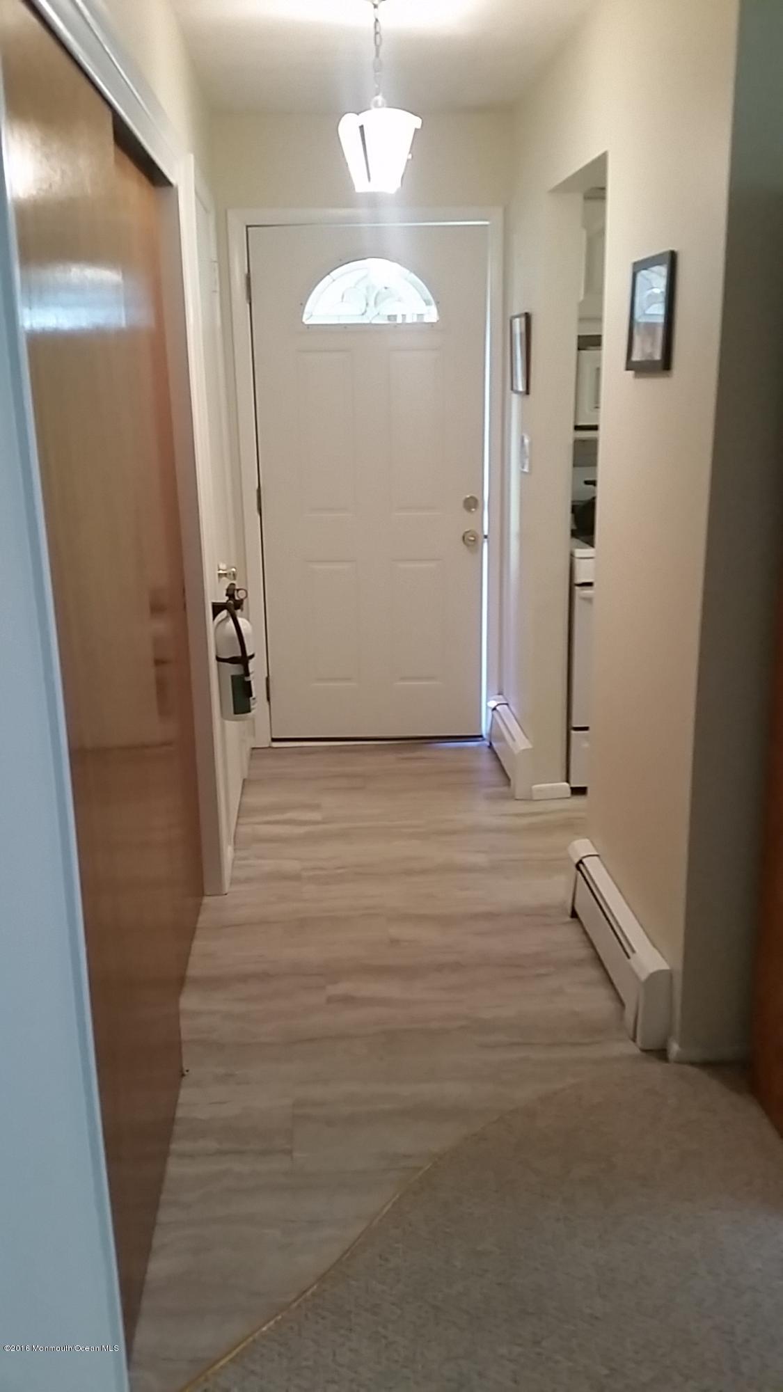 24 East Road, Unit A Jackson, NJ 08527 - Photo 6 of 24 a view of a hallway with wooden floor and staircase