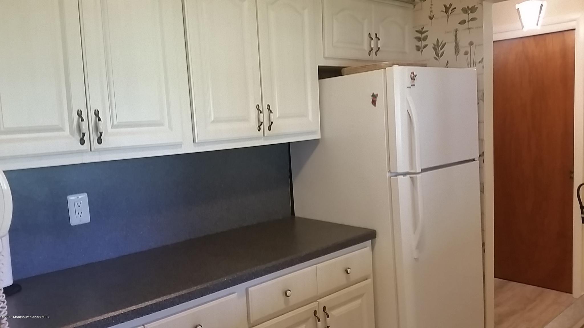 24 East Road, Unit A Jackson, NJ 08527 - Photo 7 of 24 a white refrigerator freezer sitting inside of a kitchen