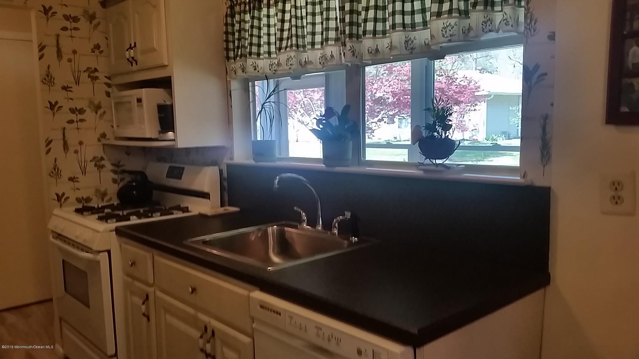 24 East Road, Unit A Jackson, NJ 08527 - Photo 9 of 24 a kitchen that has a sink and a stove