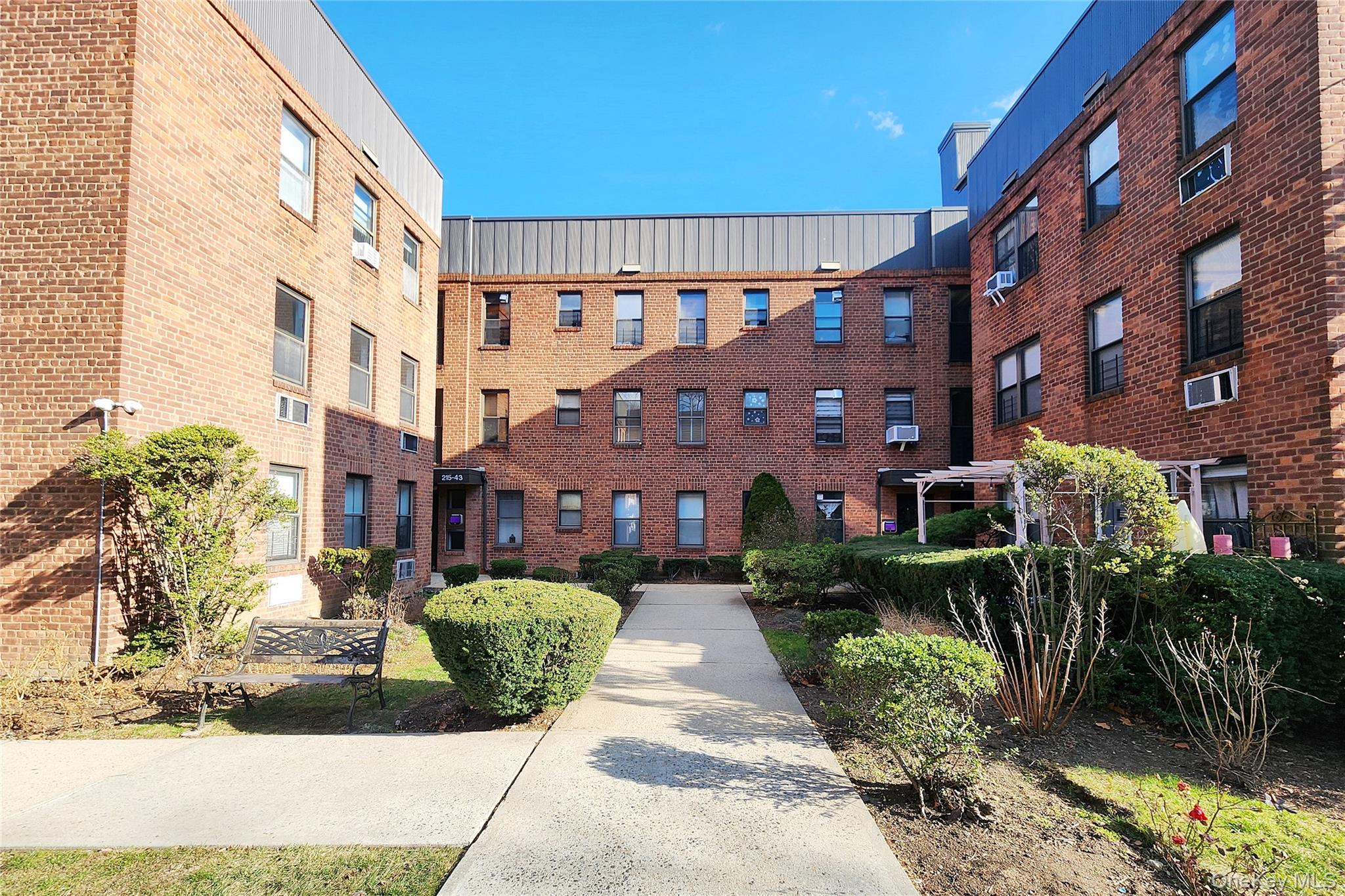 215-43 48th Avenue, Unit 3B Queens, NY 11364 - Photo 1 of 14 a view of a building with a garden