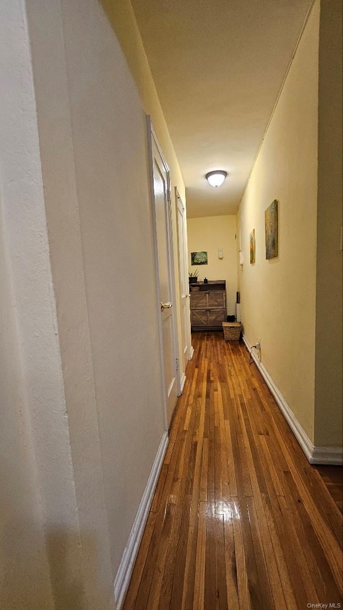 215-43 48th Avenue, Unit 3B Queens, NY 11364 - Photo 6 of 14 a view of a hallway with wooden floor and furniture