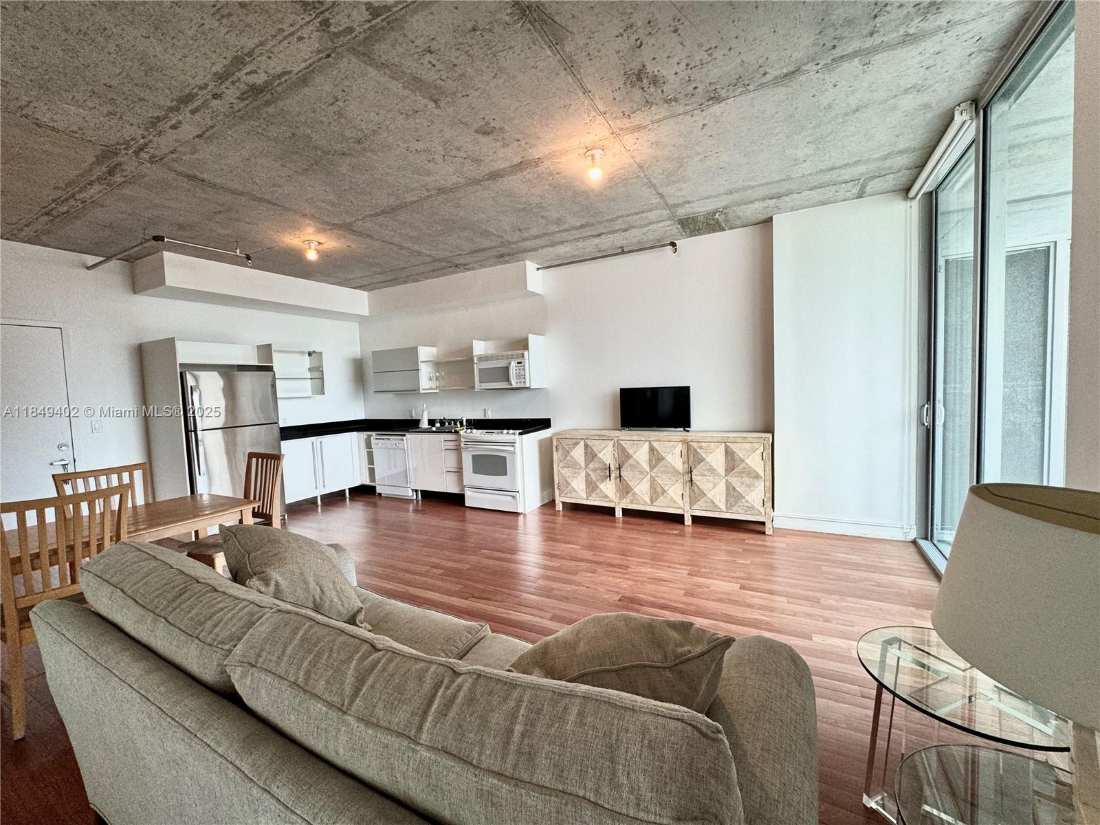 690 Southwest 1st Court, Unit 2123 Miami, FL 33130 - Photo 14 of 31 a living room with furniture and a table