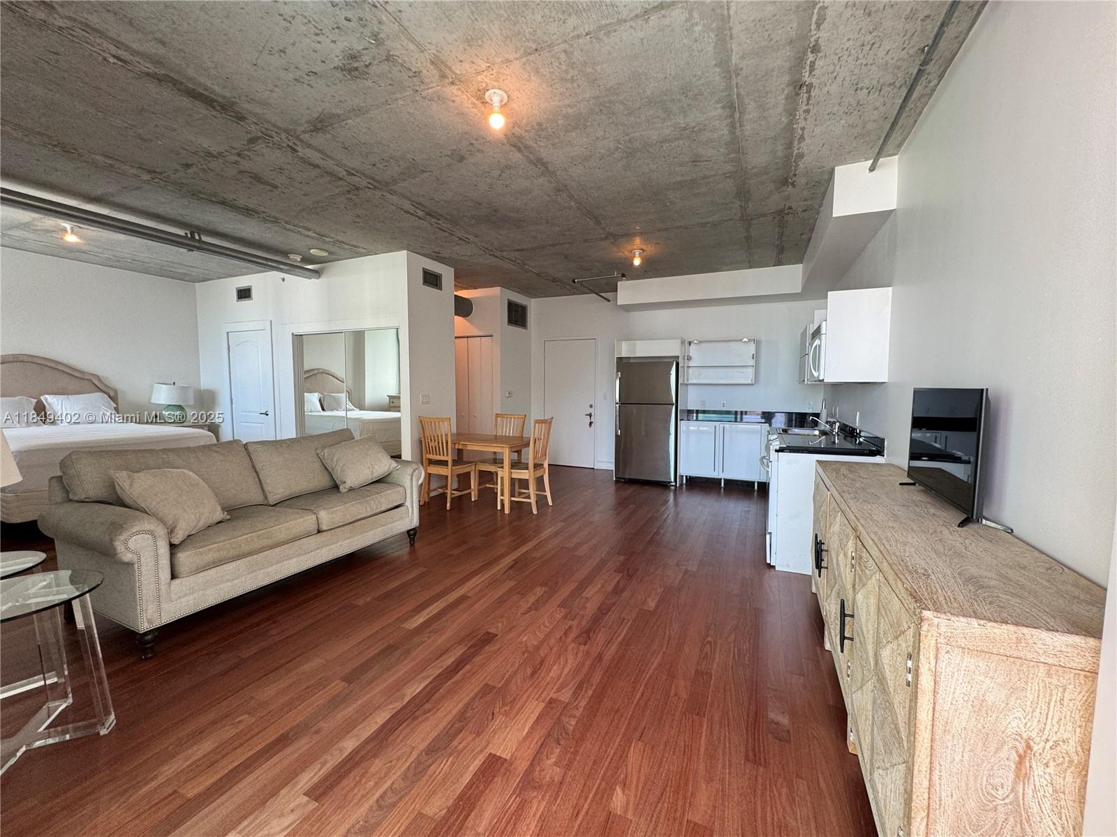 690 Southwest 1st Court, Unit 2123 Miami, FL 33130 - Photo 21 of 31 a living room with furniture and a wooden floor