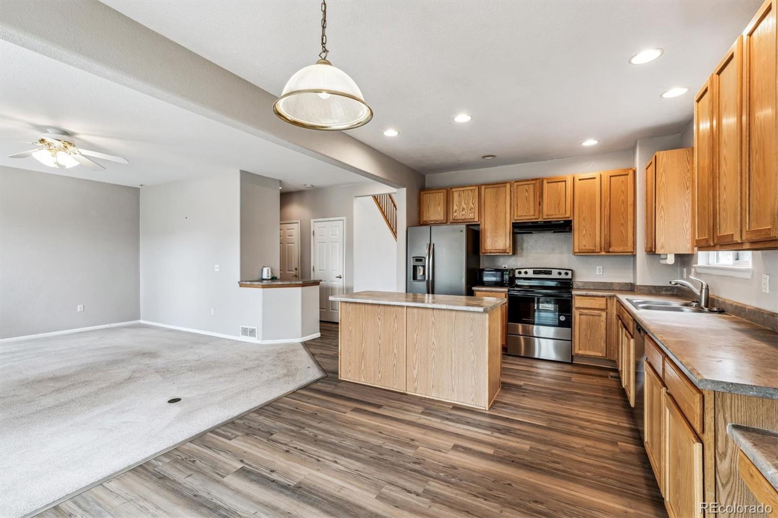 6485 Silverleaf Avenue Firestone, CO 80504 - Photo 6 of 29 a kitchen with stainless steel appliances granite countertop a sink stove and refrigerator