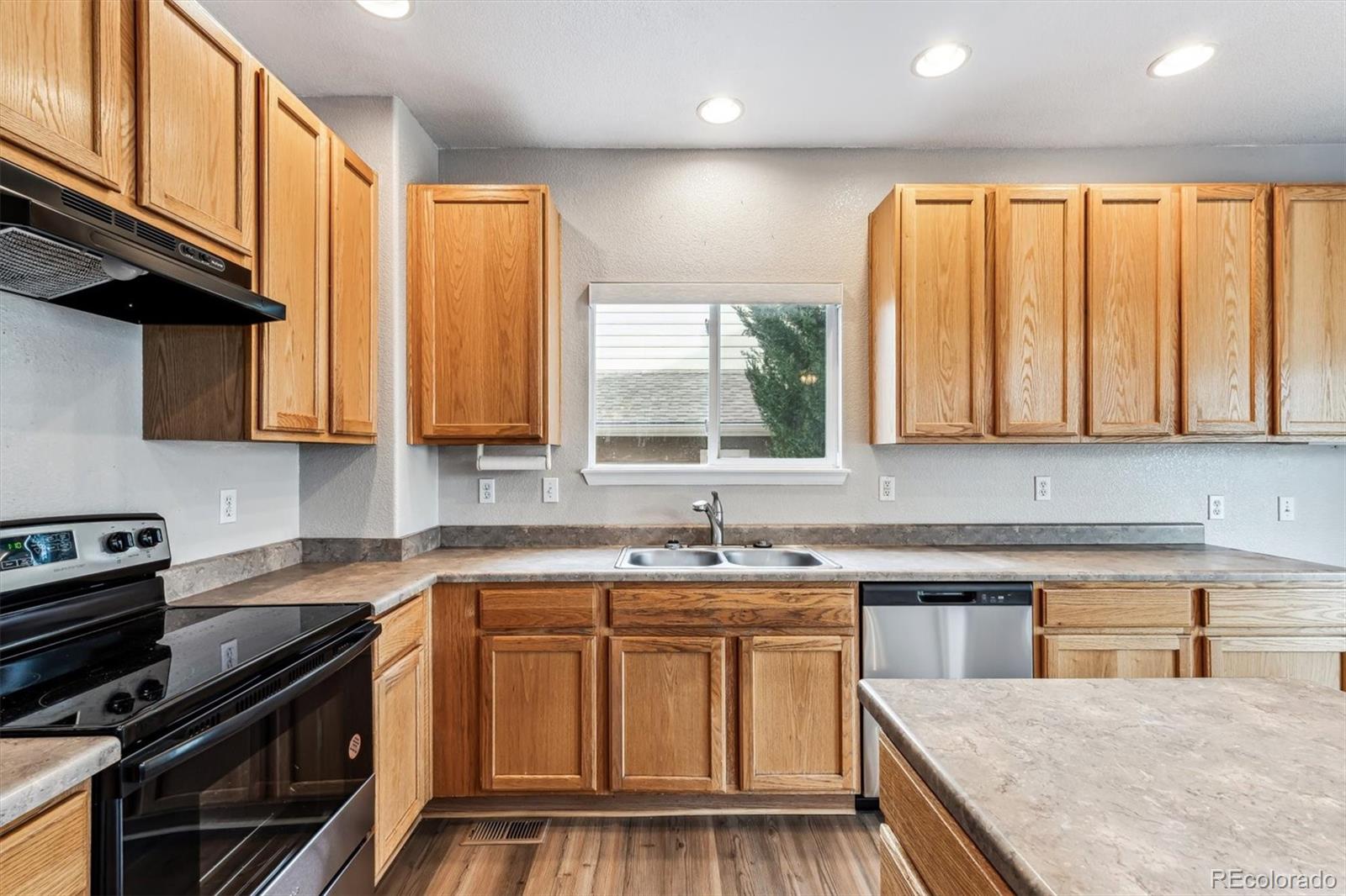 6485 Silverleaf Avenue Firestone, CO 80504 - Photo 8 of 29 a kitchen with stainless steel appliances granite countertop a stove a sink dishwasher and a microwave oven with large cabinets