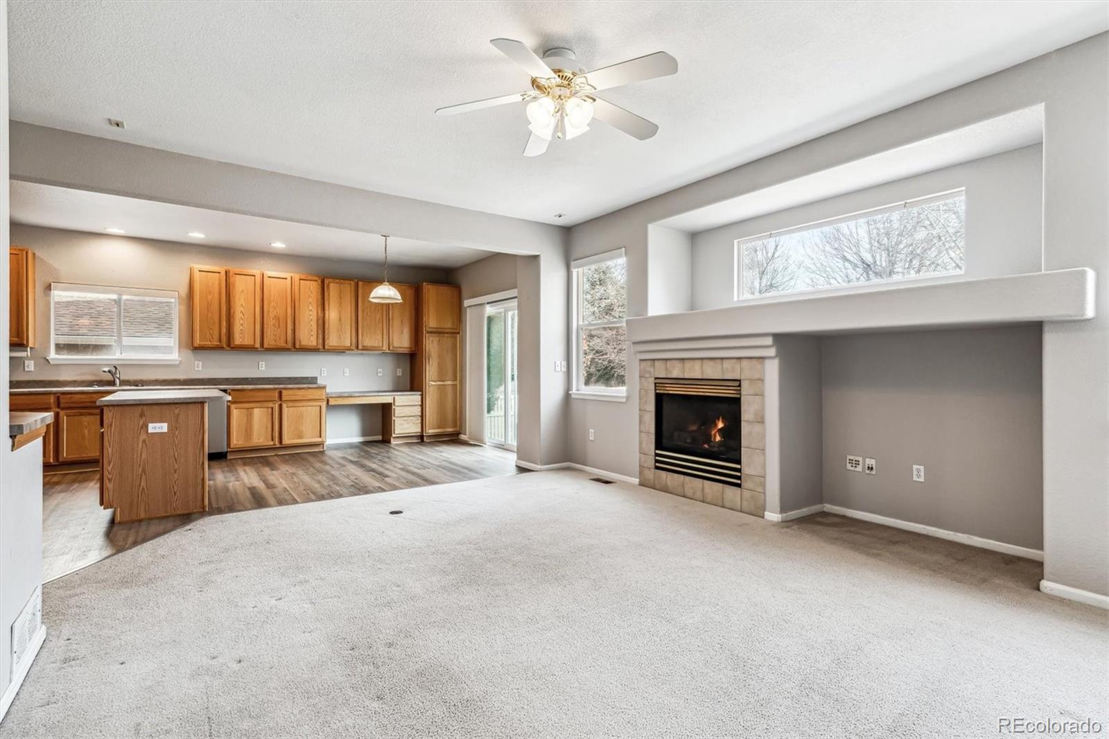 6485 Silverleaf Avenue Firestone, CO 80504 - Photo 10 of 29 a view of an empty room with a fireplace and a window