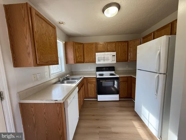 a kitchen with a refrigerator and a sink