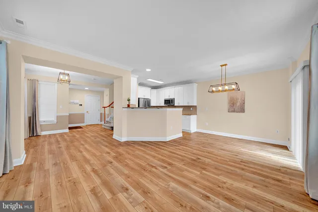 a view of a kitchen with a sink and wooden floor