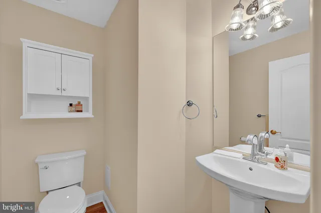 a bathroom with a sink a toilet and mirror