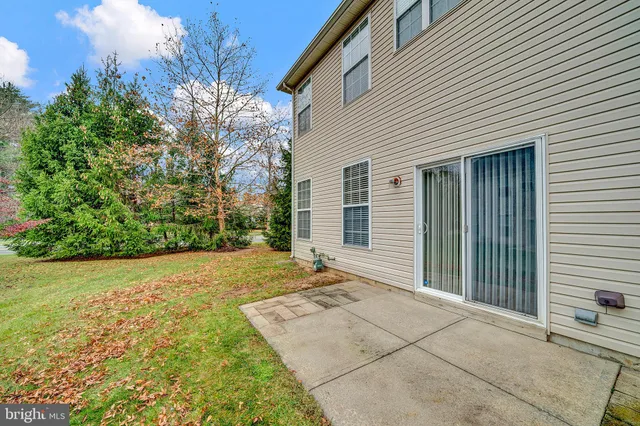 a backyard of a house with plants and trees