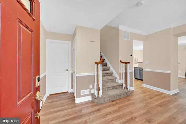 a view of entryway with wooden floor and staircase