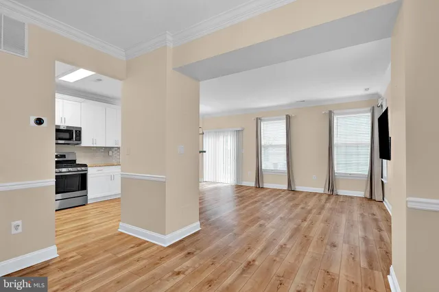 a view of a kitchen with wooden floor and a kitchen