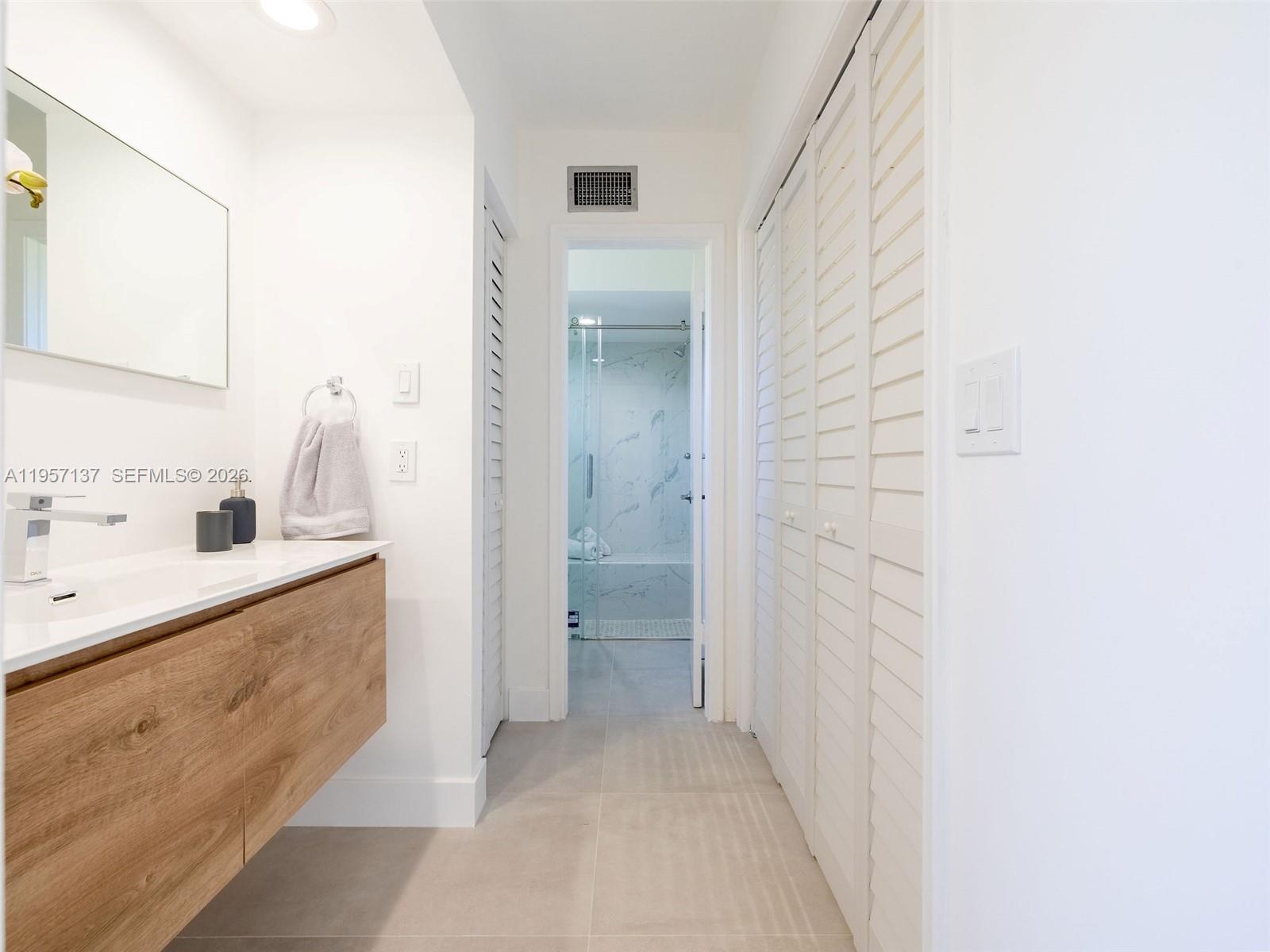10988 Lake Front Place Boca Raton, FL 33498 - Photo 17 of 85 a bathroom with a sink a toilet and shower