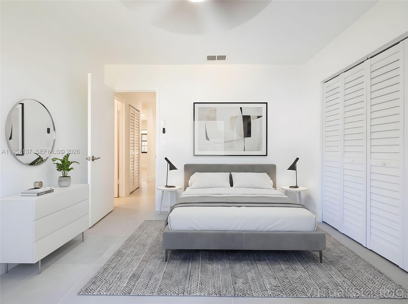 10988 Lake Front Place Boca Raton, FL 33498 - Photo 19 of 85 a bedroom with a bed a mirror and lamp