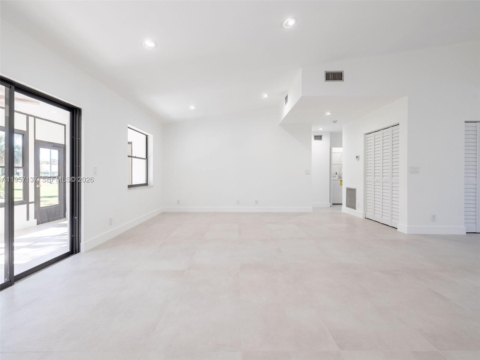 10988 Lake Front Place Boca Raton, FL 33498 - Photo 24 of 85 an empty room with a empty space and windows