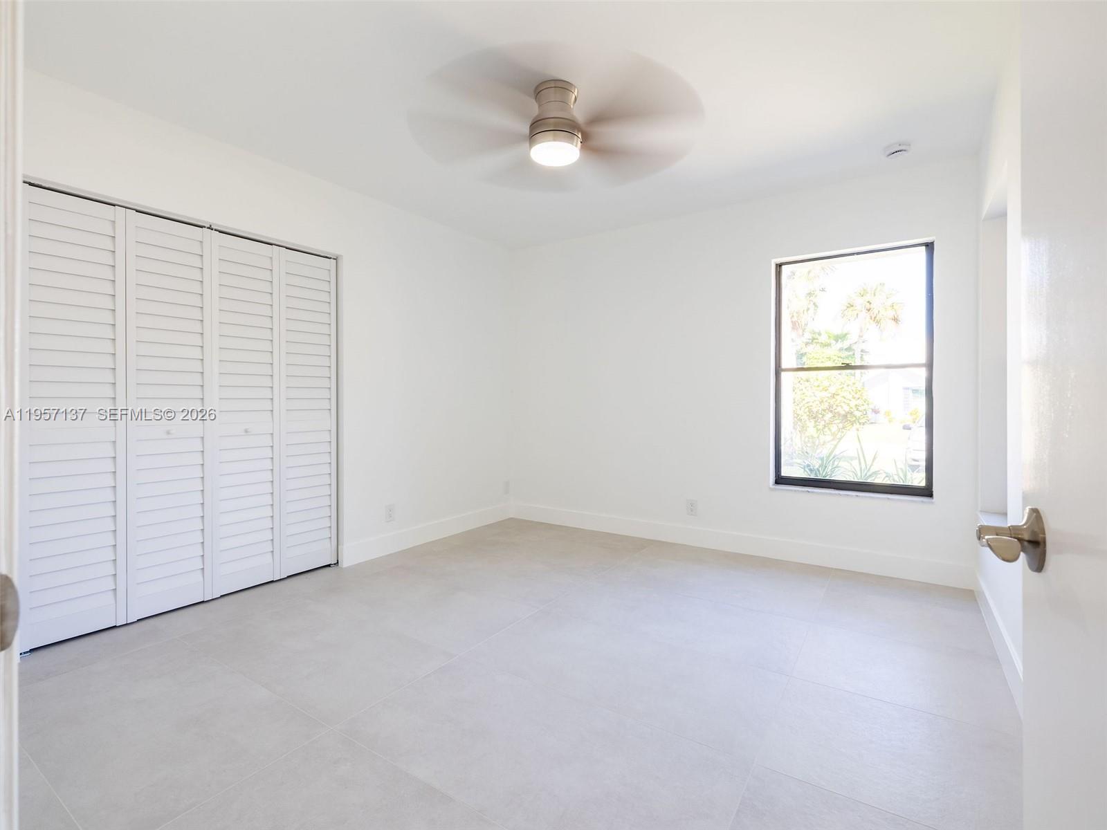 10988 Lake Front Place Boca Raton, FL 33498 - Photo 41 of 85 an empty room with a window