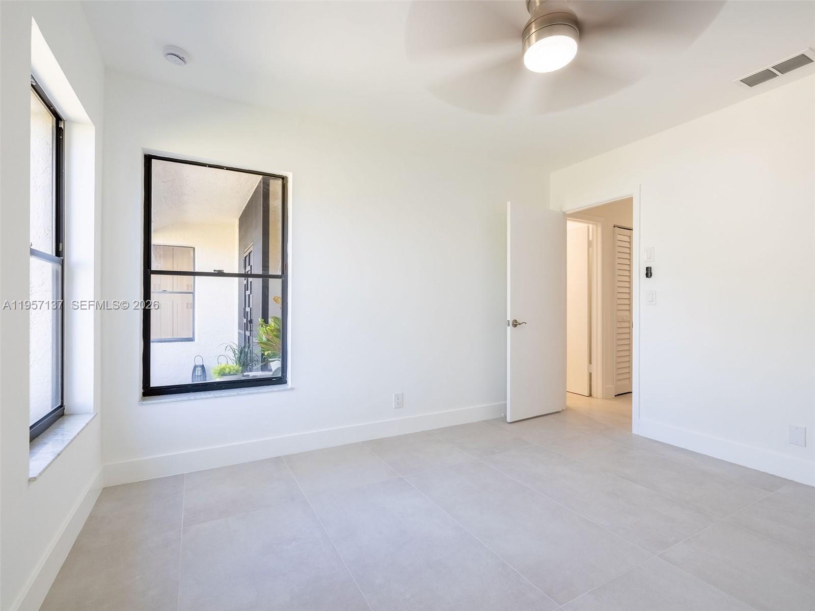 10988 Lake Front Place Boca Raton, FL 33498 - Photo 43 of 85 an empty room with windows and closet