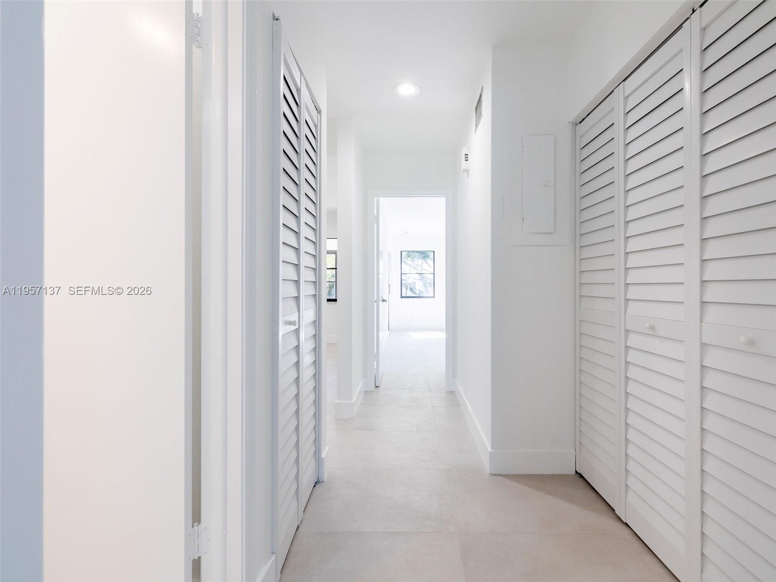 10988 Lake Front Place Boca Raton, FL 33498 - Photo 44 of 85 a view of a hallway with closet and a window