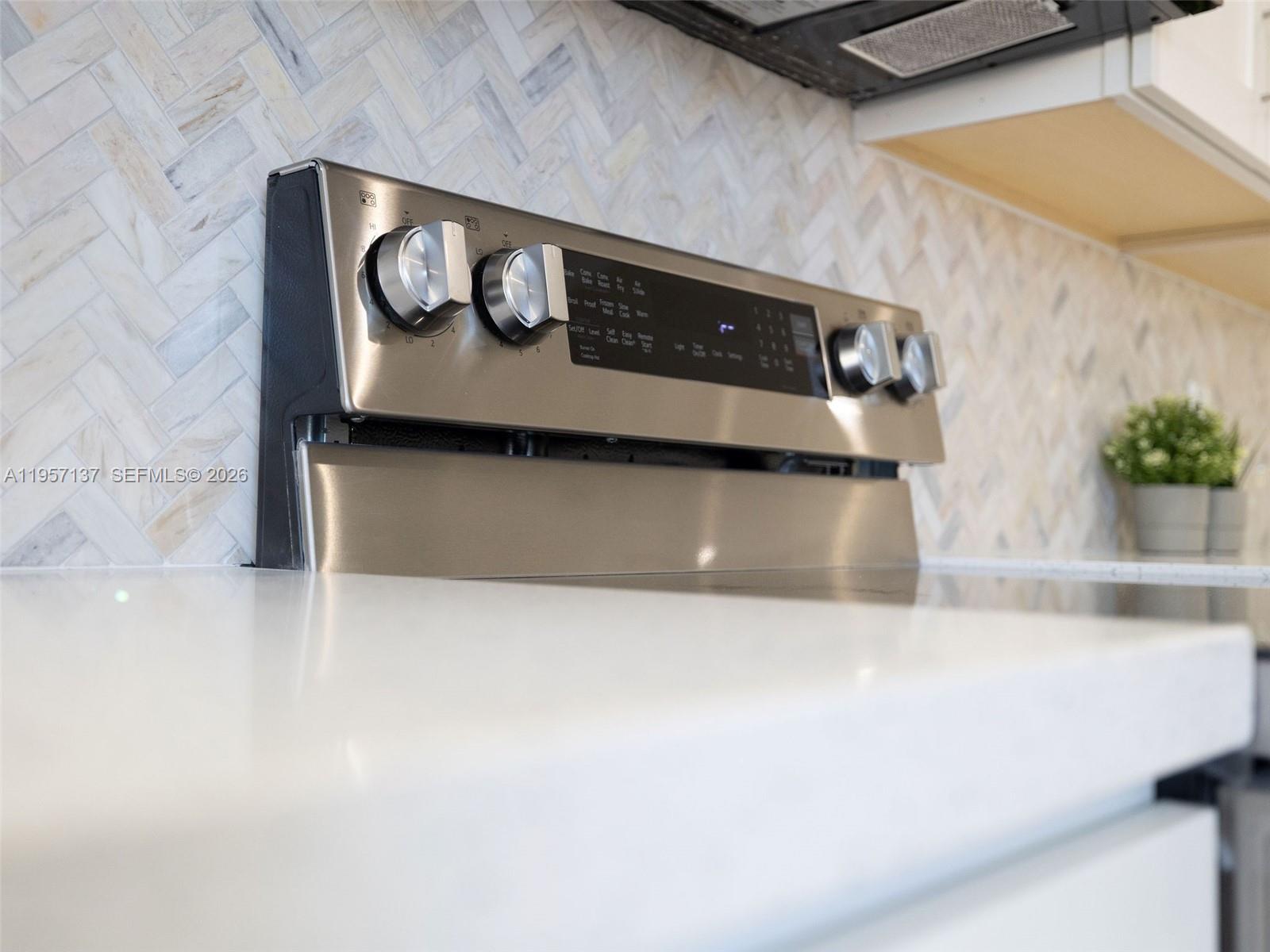 10988 Lake Front Place Boca Raton, FL 33498 - Photo 51 of 85 a kitchen with a stove and a microwave