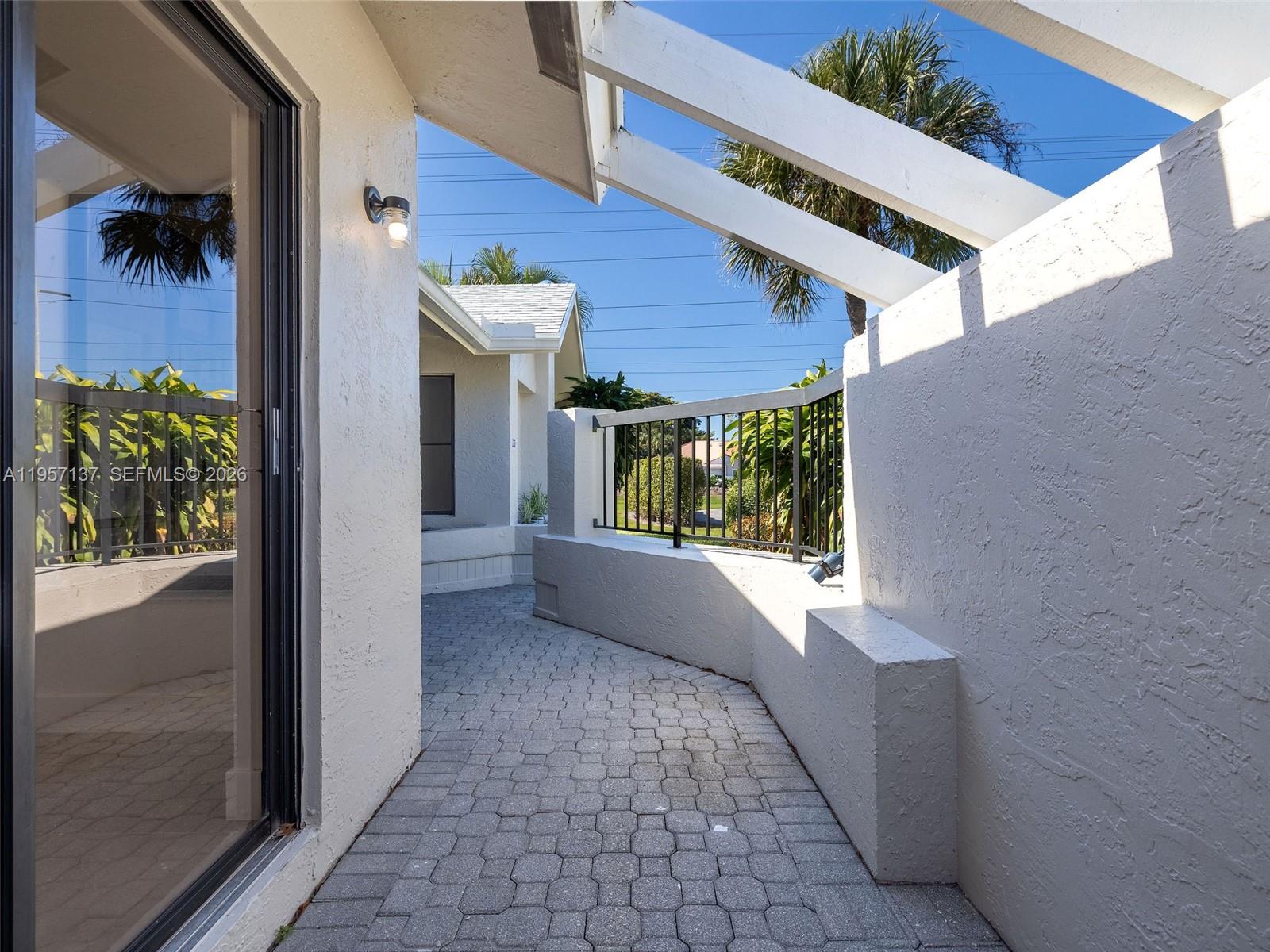 10988 Lake Front Place Boca Raton, FL 33498 - Photo 55 of 85 a view of a house with porch and wooden floor