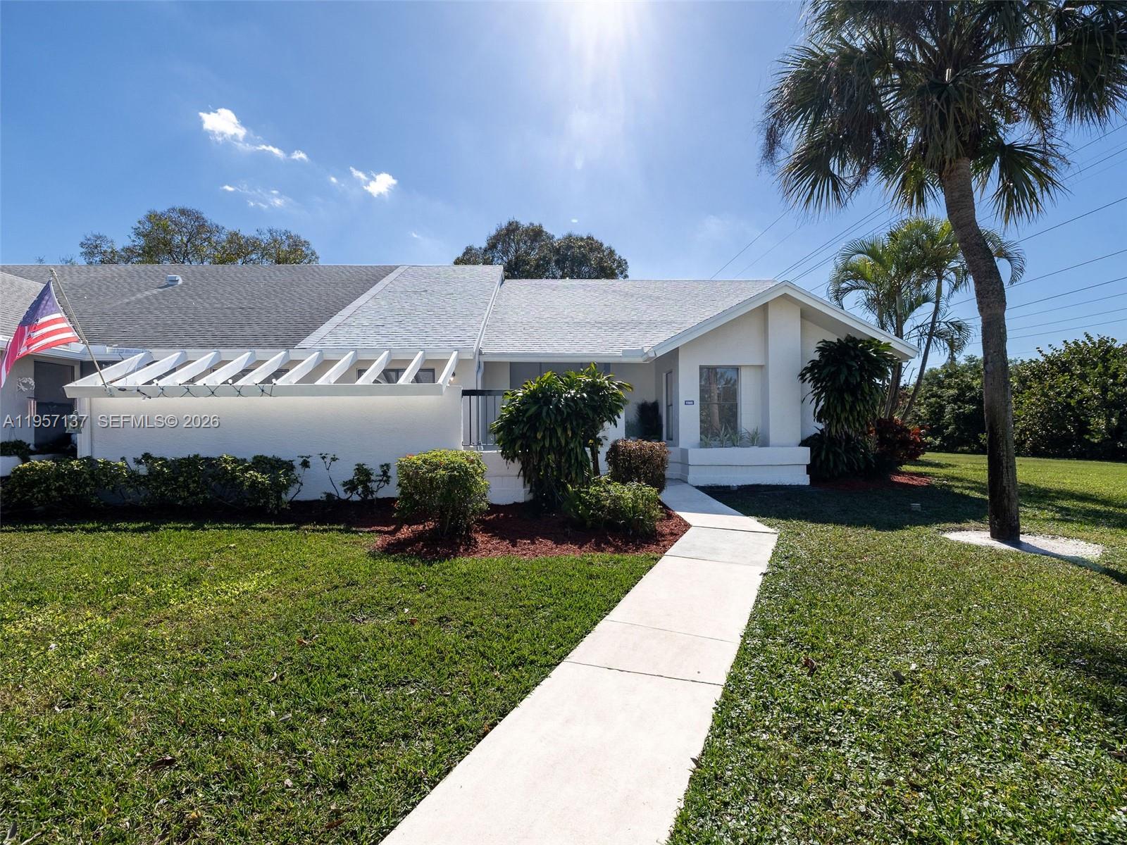 10988 Lake Front Place Boca Raton, FL 33498 - Photo 59 of 85 a front view of a house with garden