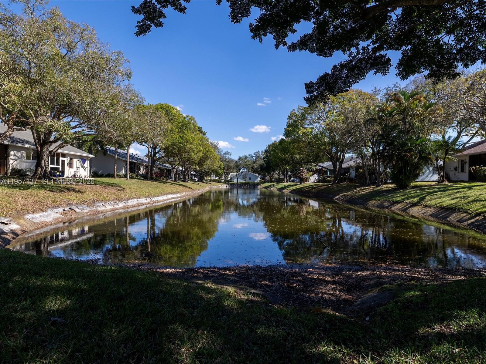 10988 Lake Front Place Boca Raton, FL 33498 - Photo 65 of 85 a view of yard with swimming pool and green space