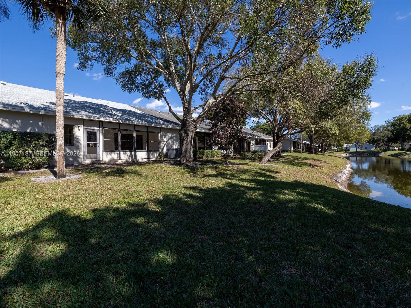 10988 Lake Front Place Boca Raton, FL 33498 - Photo 67 of 85 a view of a house with garden and trees