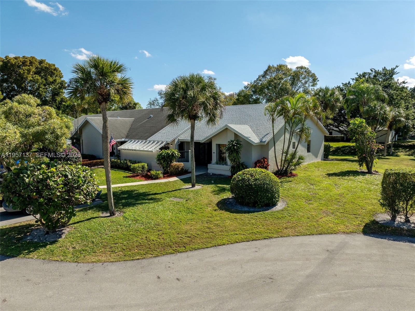 10988 Lake Front Place Boca Raton, FL 33498 - Photo 69 of 85 a front view of a house with a yard and garage