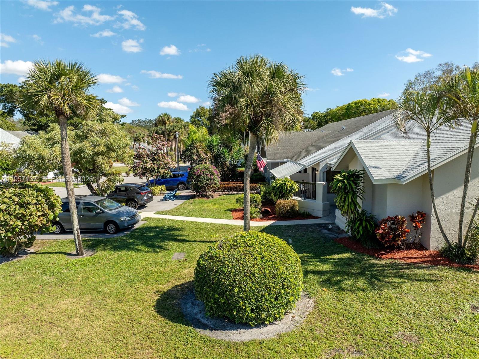 10988 Lake Front Place Boca Raton, FL 33498 - Photo 70 of 85 a view of a house with a backyard porch and sitting area