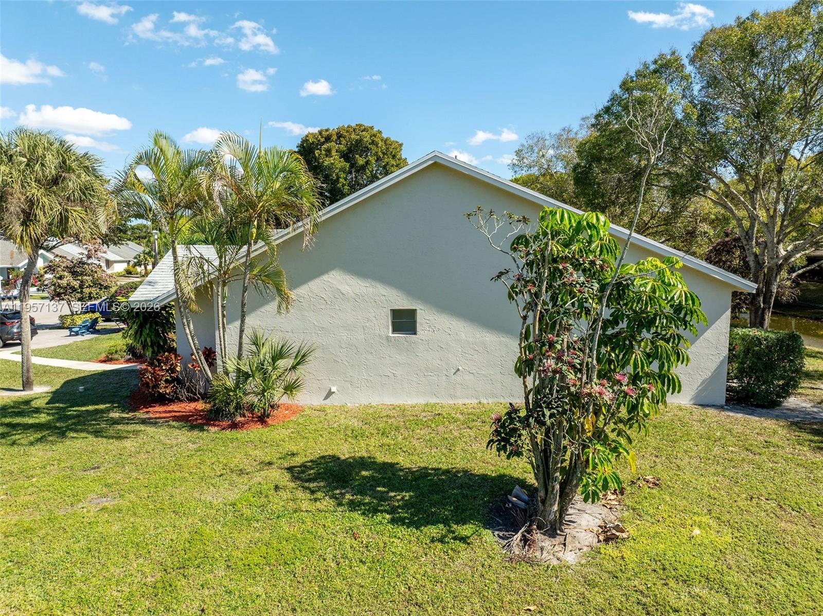 10988 Lake Front Place Boca Raton, FL 33498 - Photo 71 of 85 a backyard of a house with a yard and outdoor seating