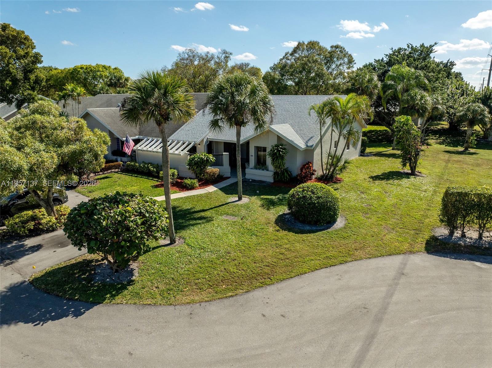 10988 Lake Front Place Boca Raton, FL 33498 - Photo 74 of 85 a view of a house with a swimming pool and a yard