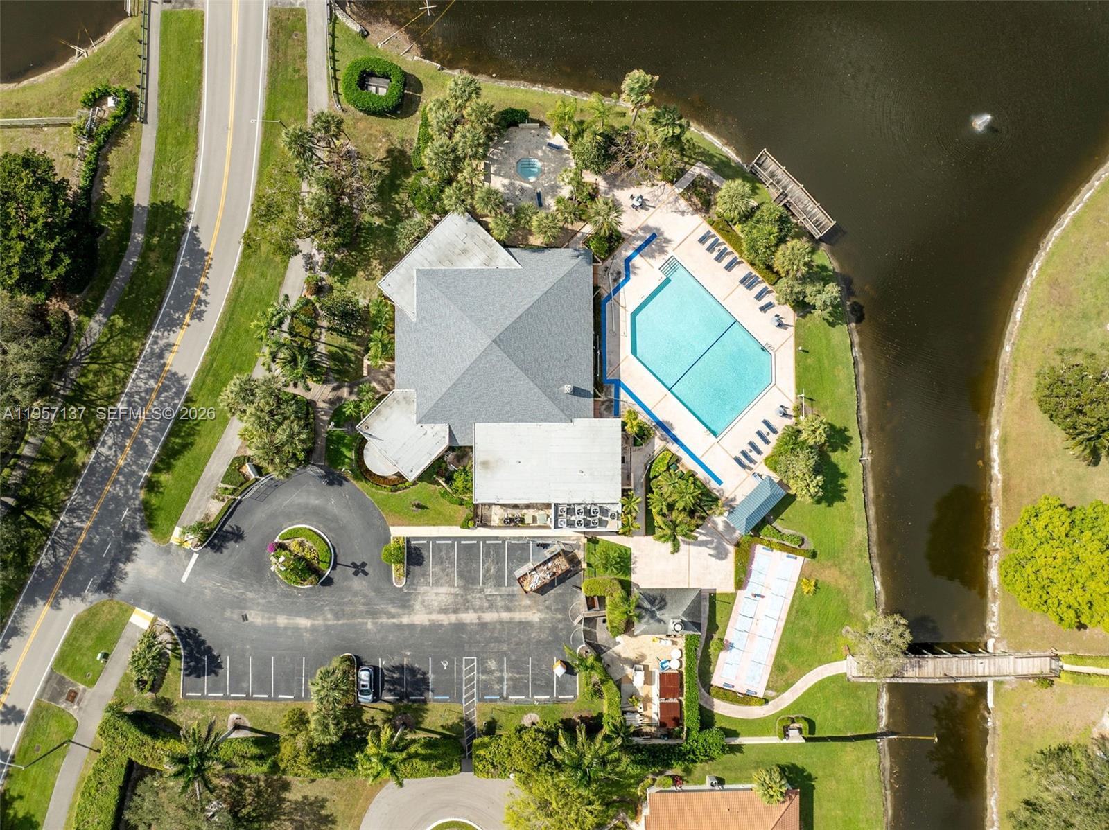 10988 Lake Front Place Boca Raton, FL 33498 - Photo 80 of 85 an aerial view of a house with a yard and a large pool