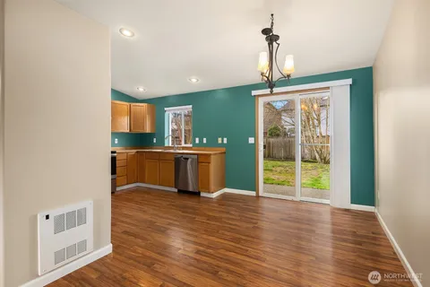 a kitchen with stainless steel appliances a refrigerator and a stove top oven