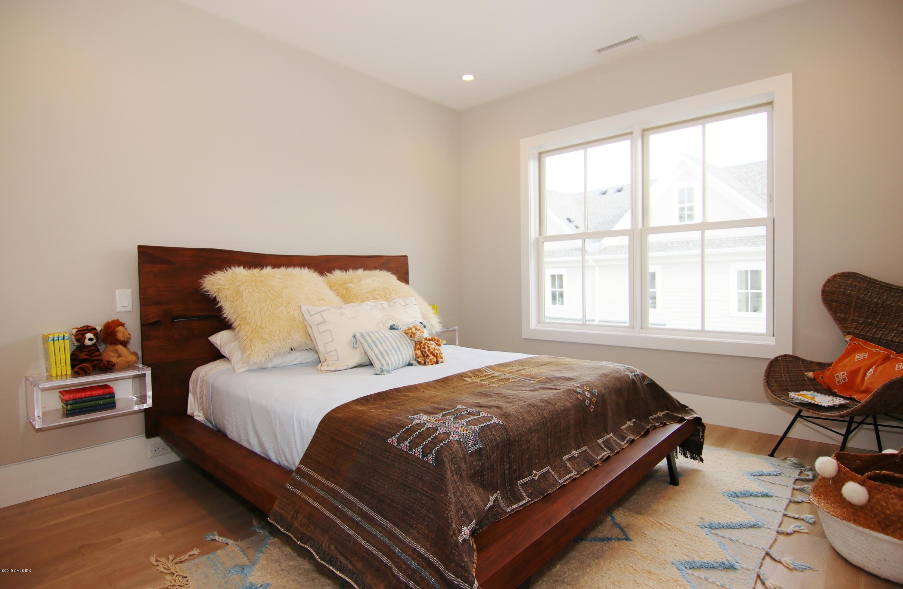 38 St Roch Avenue, Unit F Greenwich, CT 06830 - Photo 18 of 38 a bedroom with a bed and a window