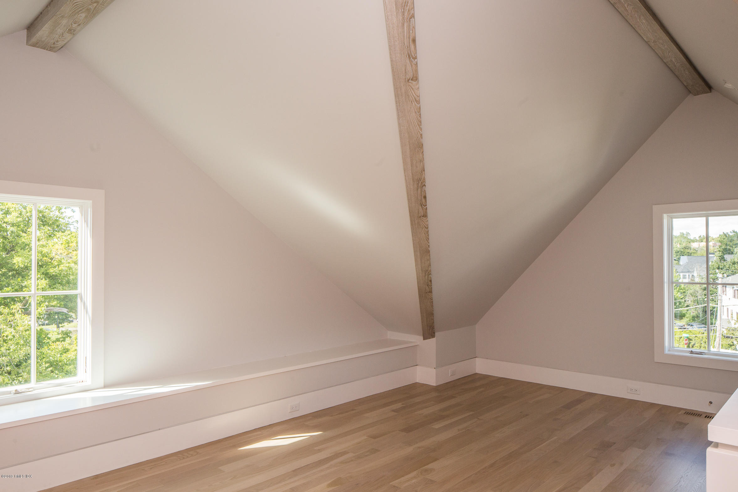 38 St Roch Avenue, Unit F Greenwich, CT 06830 - Photo 28 of 38 an empty room with wooden floor and windows