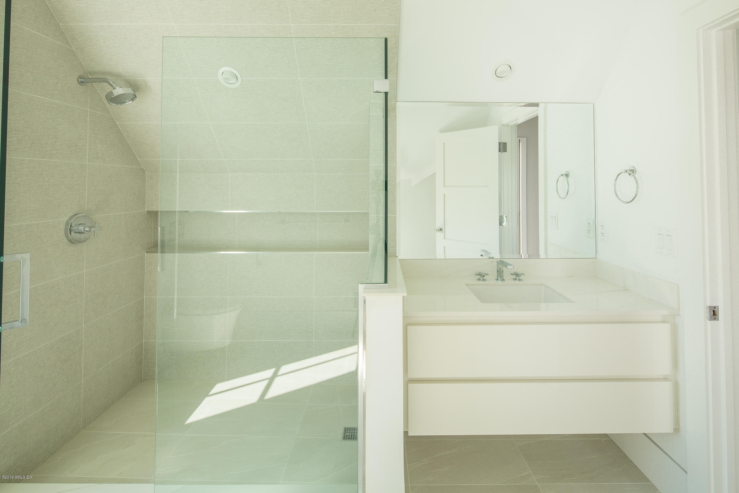 38 St Roch Avenue, Unit F Greenwich, CT 06830 - Photo 33 of 38 a bathroom with a bathtub shower sink and mirror