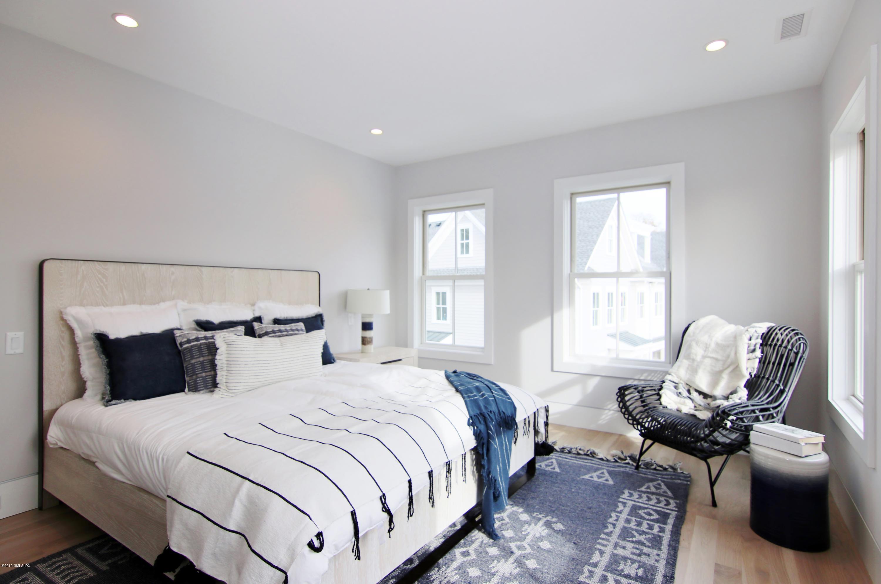 38 St Roch Avenue, Unit F Greenwich, CT 06830 - Photo 10 of 38 a bedroom with a bed and wooden floor