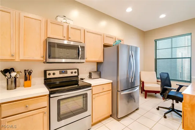 a kitchen with stainless steel appliances a stove microwave and refrigerator