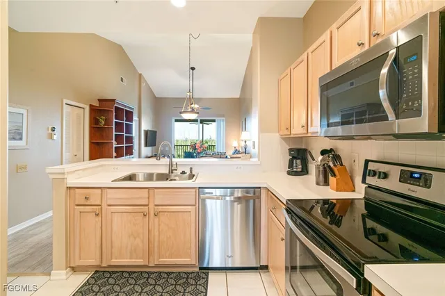 a kitchen with a sink stove and microwave