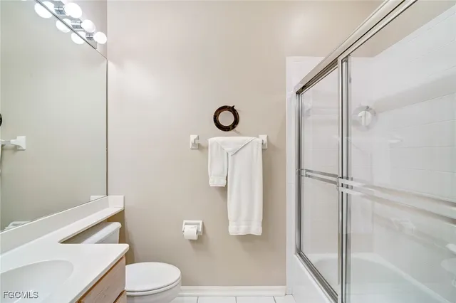 a bathroom with a toilet a sink and shower