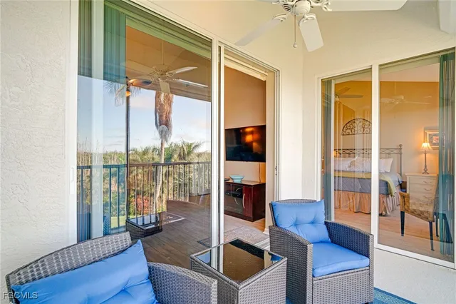 a living room with furniture and a floor to ceiling window