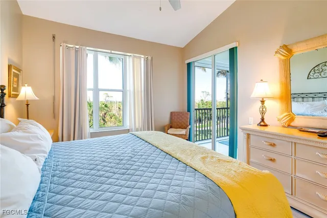 a bedroom with a bed and a dresser next to a window