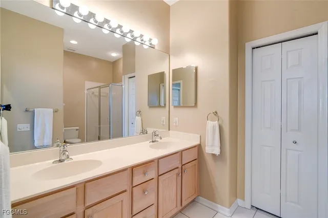 a bathroom with a double vanity sink and a mirror